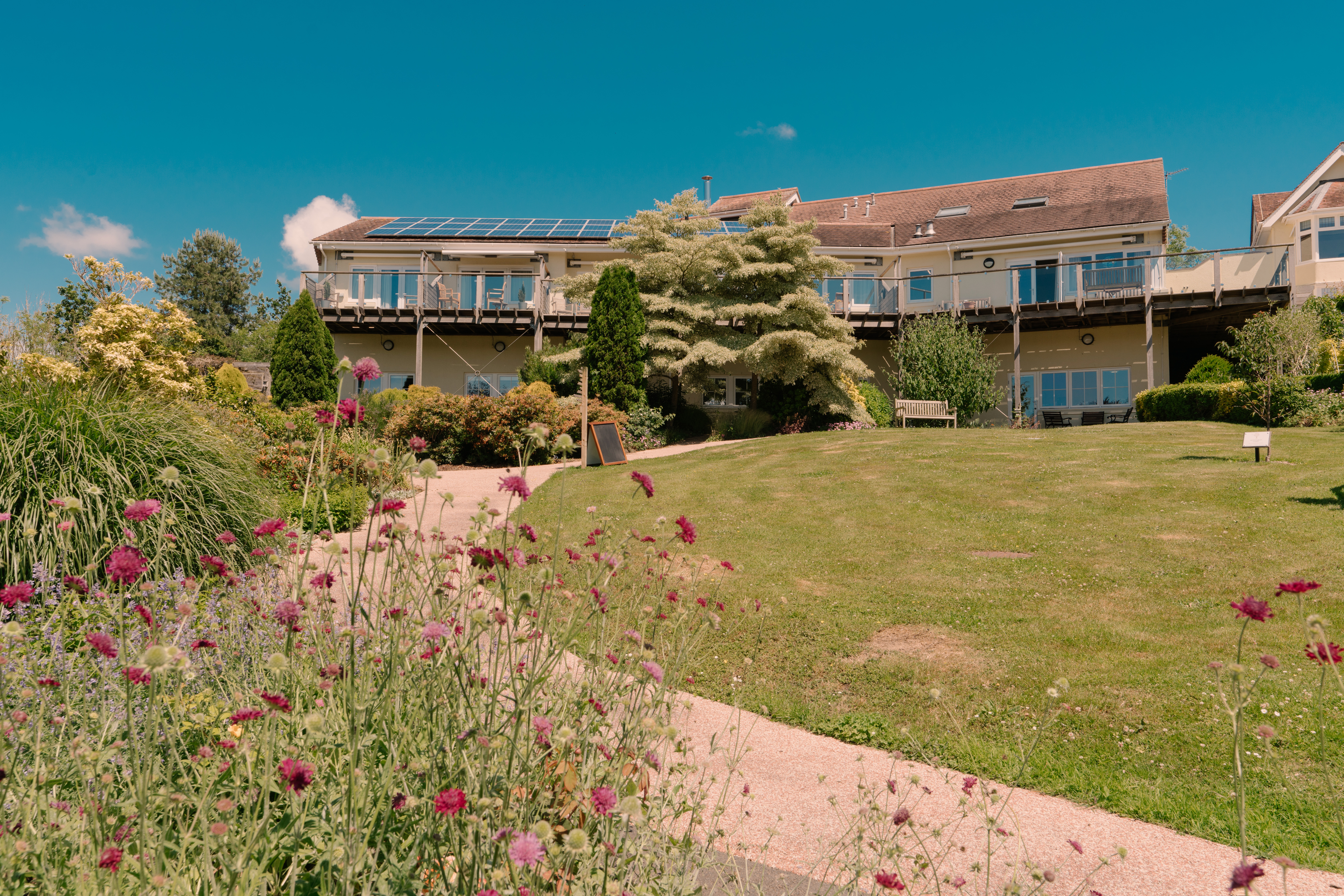 The outside of North Devon Hospice, taken from the garden, showing flowers in the foreground