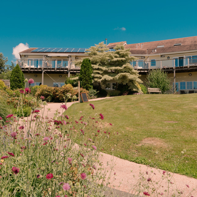 The outside of North Devon Hospice, taken from the garden, showing flowers in the foreground