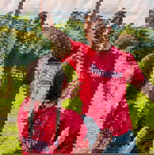 Photo of man covered in mud smiling